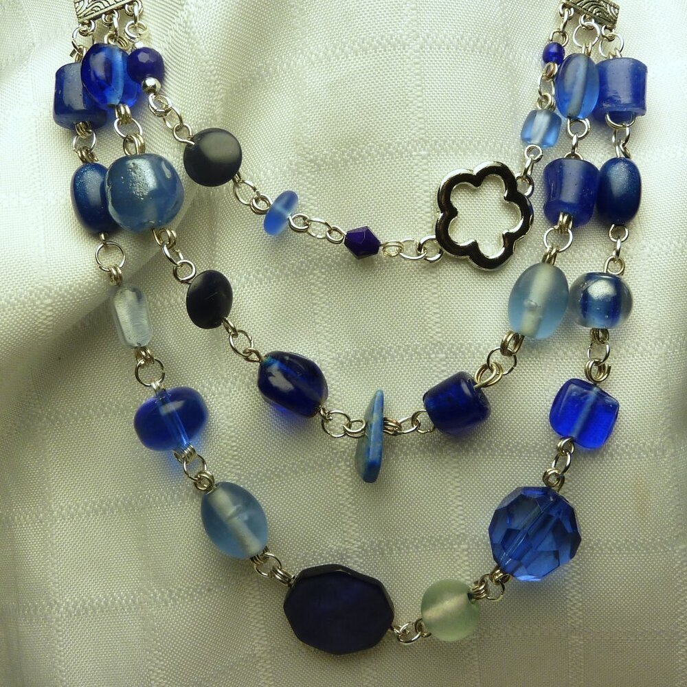 No 43 Beautiful handmade necklace with several rows of glass beads and a flower
